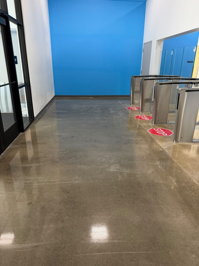 Commercial Floor Stripping and Waxing in Michigan: When and Why Your Floors Need It 3 Polished entrance floor beside security turnstiles – Champion Facility Solutions