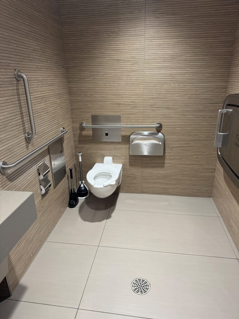 Clean accessible restroom with grab bars and tiled floor – Champion Facility Solutions