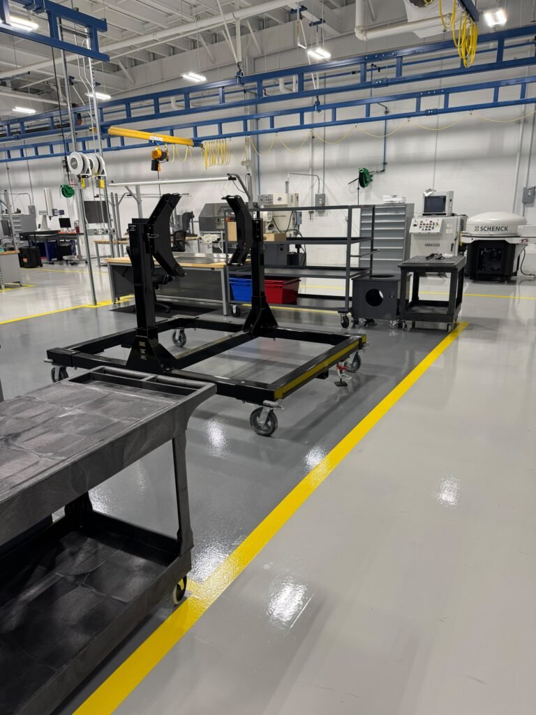 Commercial Floor Stripping and Waxing in Michigan: When and Why Your Floors Need It 2 Clean epoxy warehouse floor with yellow safety lines – Champion Facility Solutions